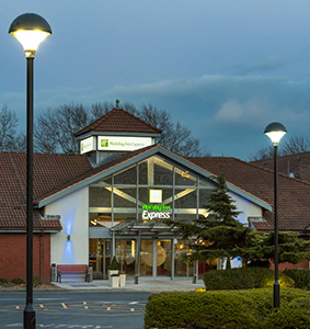 Evening image of holiday inn express building featuring street lighting