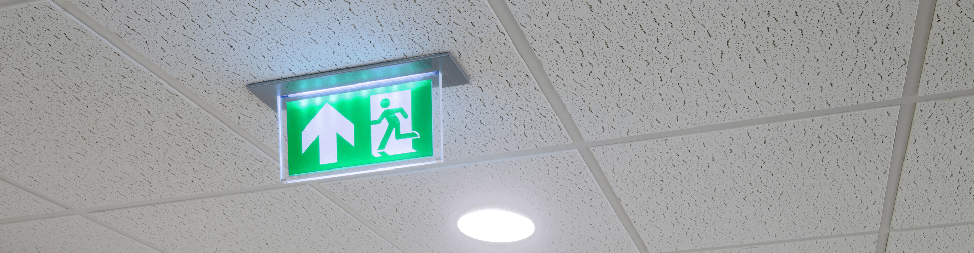 Up arrow emergency exit light on ceiling
