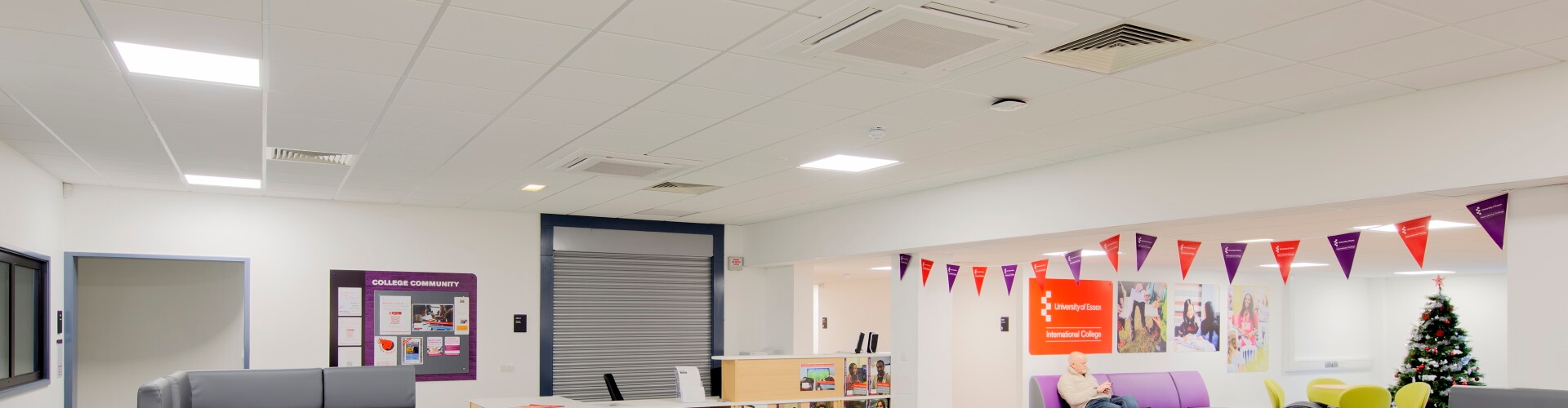 led panels in a room decorated with a Christmas tree